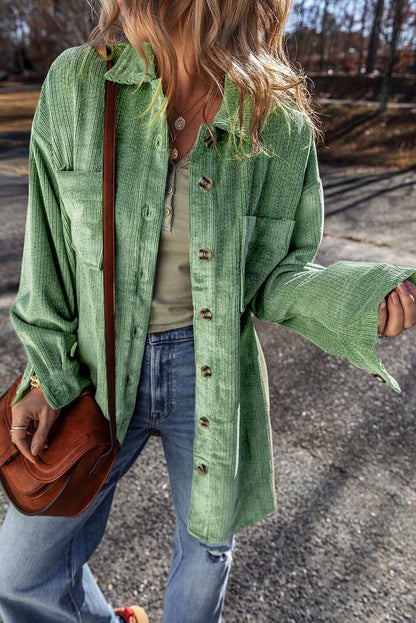 Pocketed collared neck button up shacket in green.