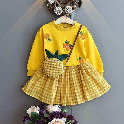 Embroidered sweater with plaid skirt suit and pineapple design.