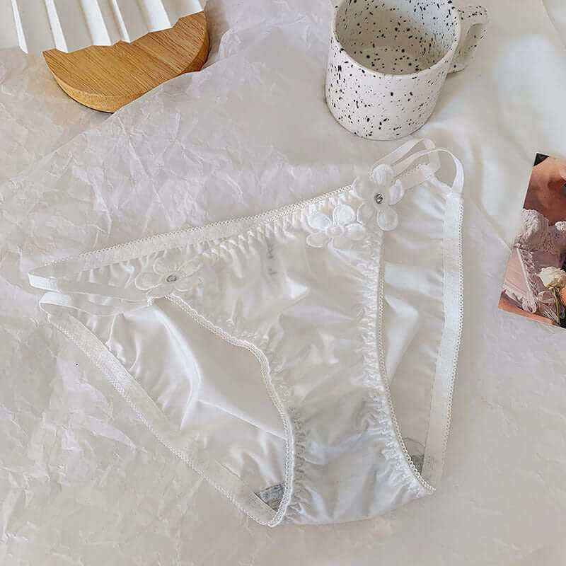 Silky embroidered floral low waist briefs in milk silk fabric.