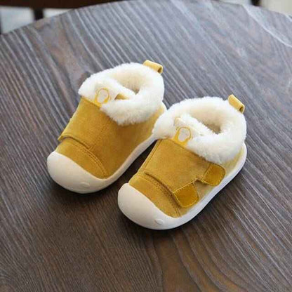 Velvet and cotton toddler shoes on wooden surface, designed for warmth, comfort, and non-slip wear.