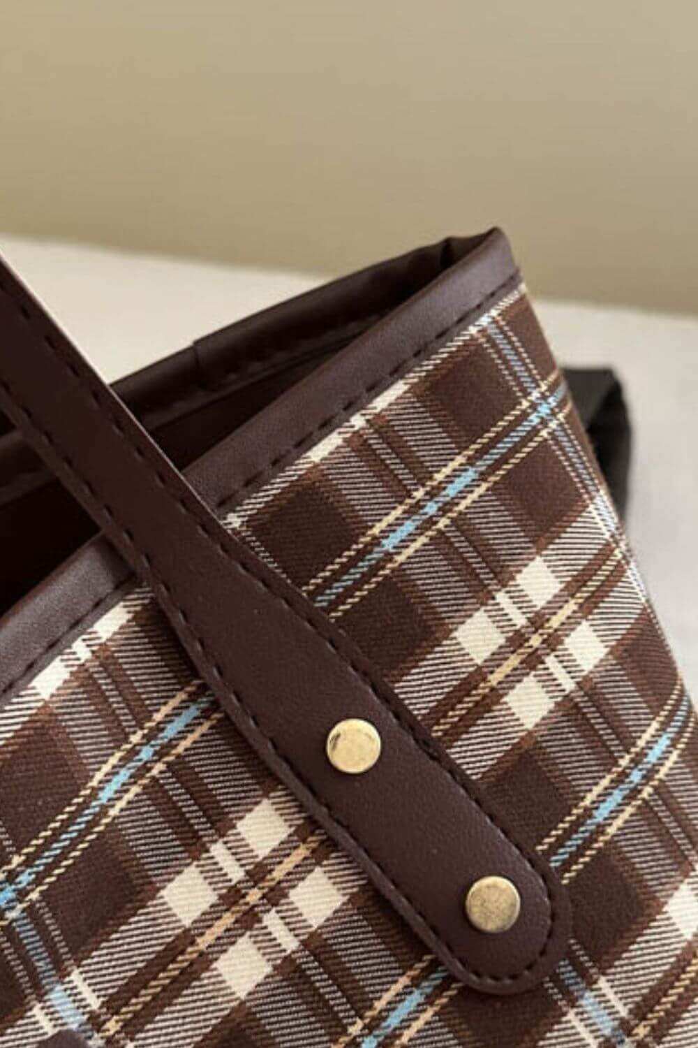 Plaid leather tote bag for women with chic design and spacious interior.