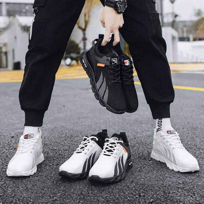 Men's mesh sneakers, lightweight and breathable, in black and white color-block design, ideal for casual and sports wear.