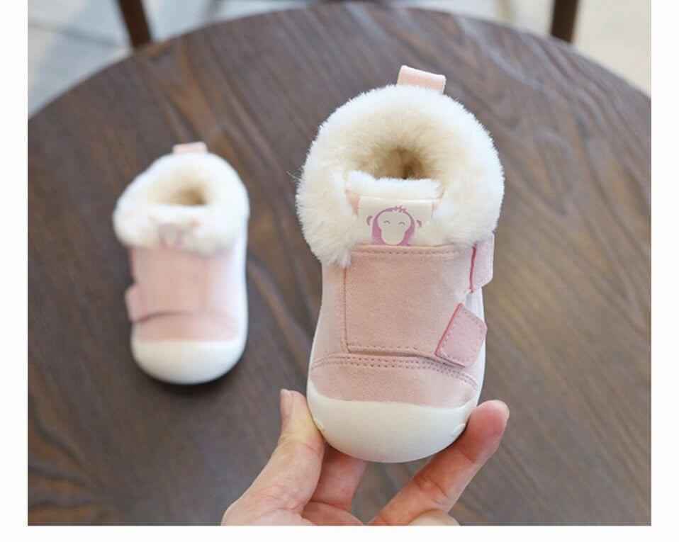 Pink toddler shoes with fur lining, non-slip sole, and velcro strap.