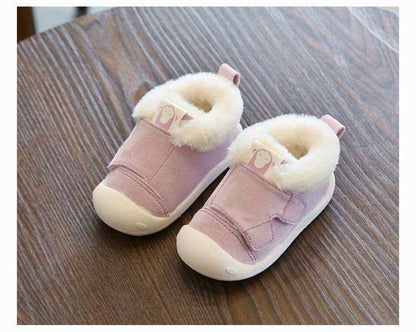 Pink toddler shoes with velvet and cotton lining, non-slip sole, on a wooden surface.