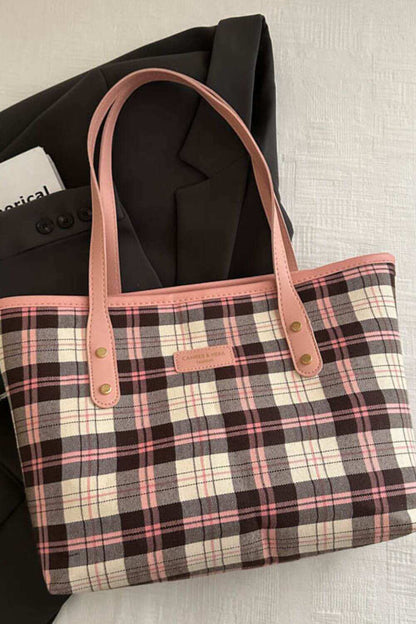 Plaid leather tote bag for women with pink handles and spacious interior.