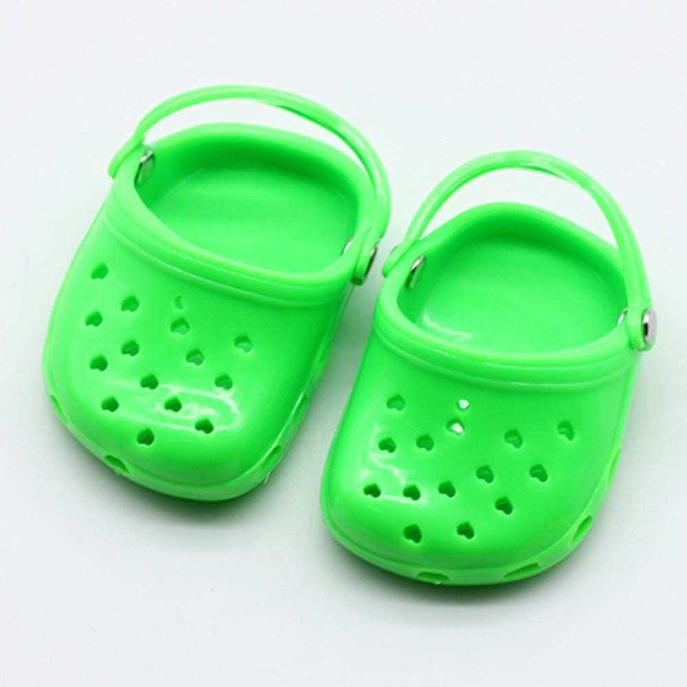 Green children doll beach slippers made of durable plastic.