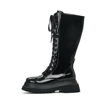 Thick-soled round toe side zipper high boots for women with black patent finish.