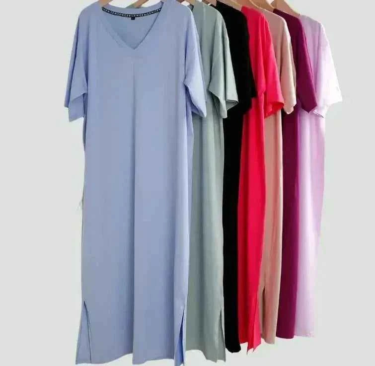 Oversized V neck women boho dresses in various colors hanging on a rack.