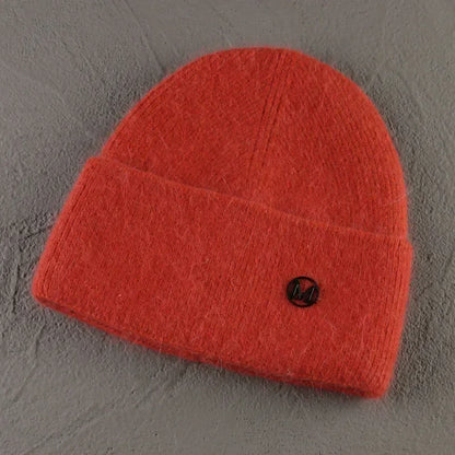 Women solid color fur knitted bonnet beanie for warmth and style.