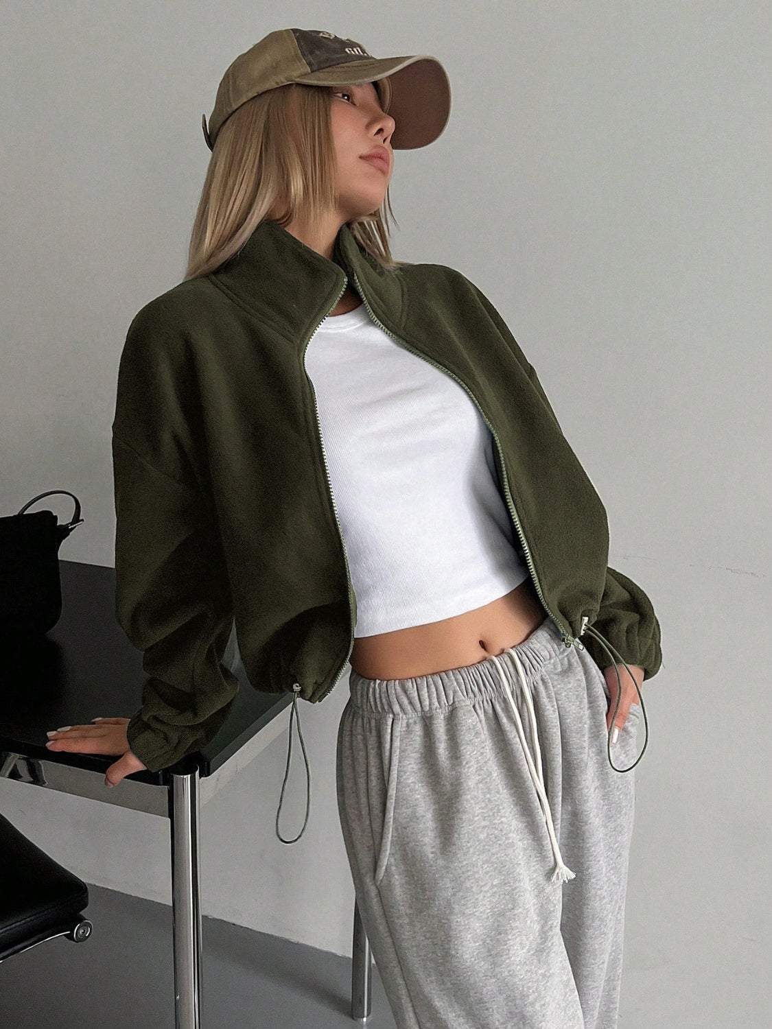 Honey zip up long sleeve cropped jacket in thin polyester fabric, shown in an olive color.