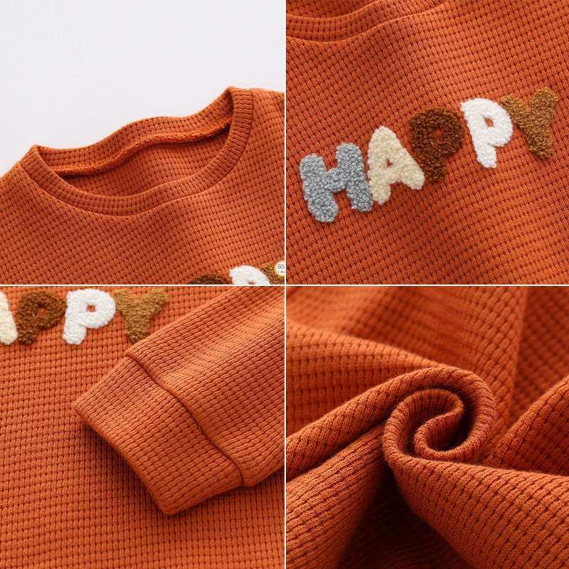 Boys' fashion waffle top trousers in cotton, featuring the word "Happy" in a knitted texture.