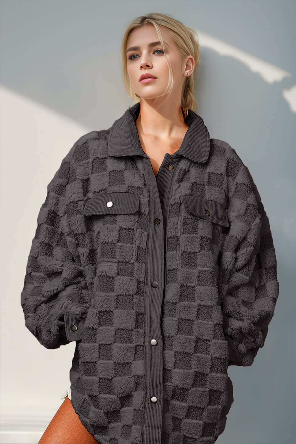 Fuzzy checkered shacket with button-up design and functional pockets.