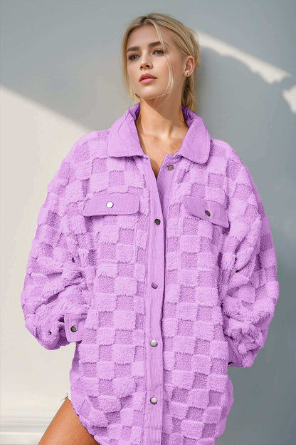 Fuzzy checkered shacket with button closure and pockets in purple.