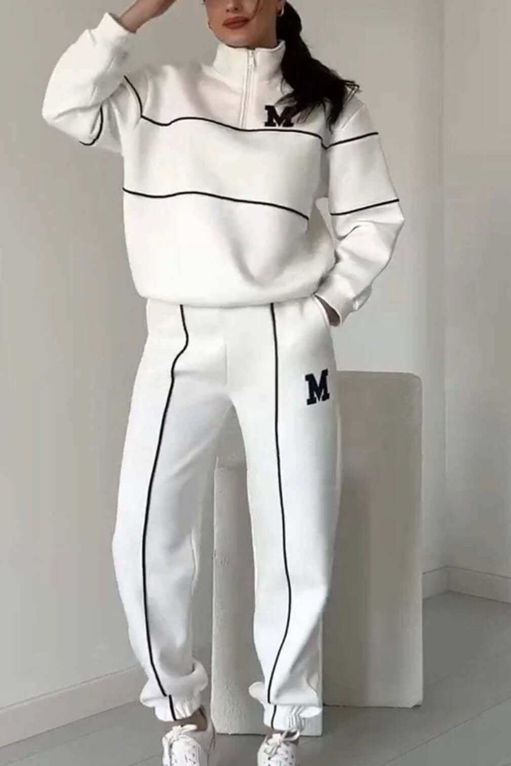 Women's fashion lounge hoodless pullover sweatsuit set with pockets, showcasing stylish stripes and a comfortable fit in white.