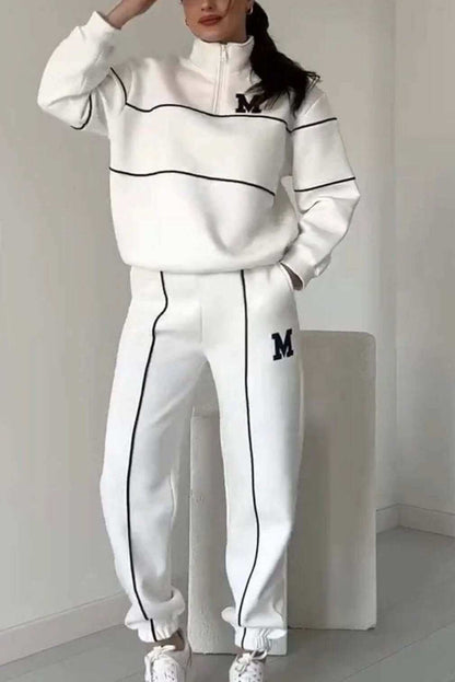 Women's fashion lounge hoodless pullover sweatsuit set with pockets, showcasing stylish stripes and a comfortable fit in white.